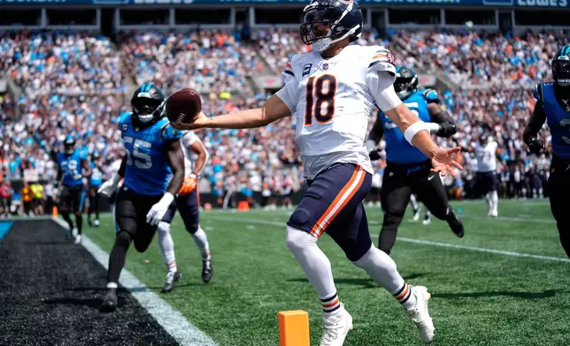 Chicago Bears quarterback Caleb Williams (18) runs to score a touchdown during the first half of an NFL football game, Sunday, Sept. 13, 2026, in Charlotte, N.C. (AP Photo/Erik Verduzco)