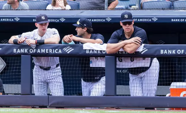 New York Yankees' Ben Rice, left, Spencer Jones, center, and Aaron Judge, right, lean on the dugout rail in the first inning during a baseball game against the Boston Red Sox, Sunday, Aug. 30, 2026, in New York. (AP Photo/Corey Sipkin)