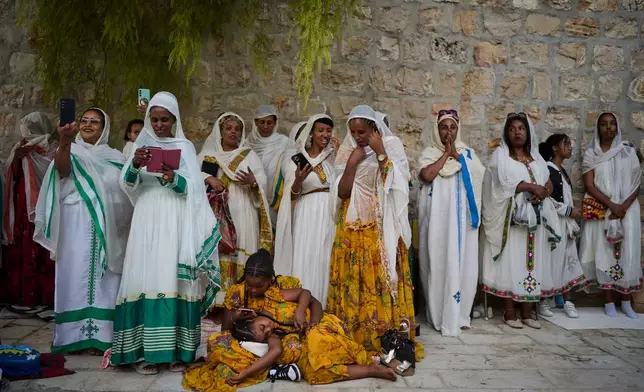 Ethiopian Orthodox Christian worshippers gather for celebrations on the eve of the Meskel holiday at the Ethiopian monks' village, Deir Al‑Sultan, located on the rooftop of the Church of the Holy Sepulcher in Jerusalem's Old City, Saturday, Sept. 26, 2026. (AP Photo/Ohad Zwigenberg)