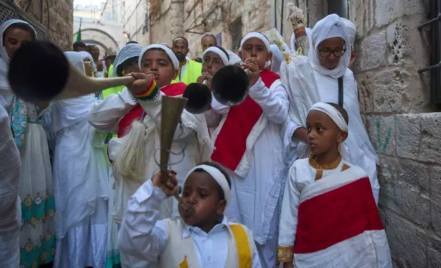 Ethiopian Orthodox Christian worshippers beat drums and sing to celebrate the eve of the Meskel holiday in the streets of Jerusalem's Old City, Saturday, Sept. 26, 2026. (AP Photo/Ohad Zwigenberg)
