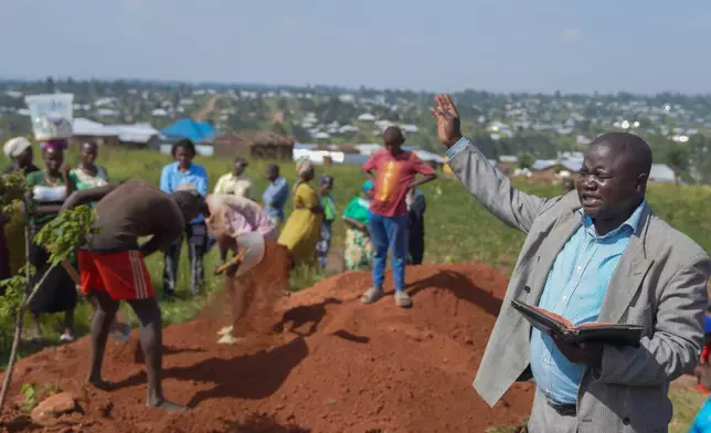 A pastor leads a service during the burial ceremony of Neema Minaro, a 66 year old woman who died of the Ebola virus, in Bunia, Congo, Wednesday, Sept. 2, 2026. (AP Photo/Dieudonne Dirole)