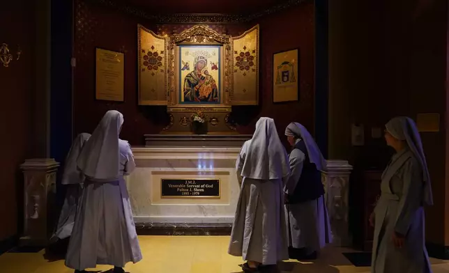 Nuns pray at the tomb of Archbishop Fulton Sheen at the Cathedral of St. Mary of the Immaculate Conception in Peoria, Ill., on July 15, 2026. (AP Photo/Jessie Wardarski)