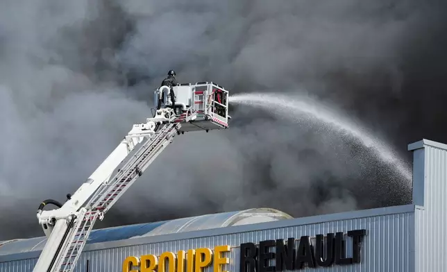 Firefighters put out a fire at warehouse stores after a Russian air attack in Kyiv, Ukraine, Wednesday, Sept. 2, 2026. (AP Photo/Efrem Lukatsky)