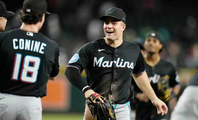 Miami Marlins' Jakob Marsee, right, celebrates a win against the Arizona Diamondbacks with Marlins' Griffin Conine (18) after a baseball game, Wednesday, Sept. 16, 2026, in Phoenix. (AP Photo/Ross D. Franklin)