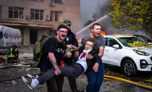People carry an injured woman into an ambulance after a Russian drone strike in Kyiv, Ukraine, Monday, Sept. 28, 2026. (AP Photo/Dan Bashakov)