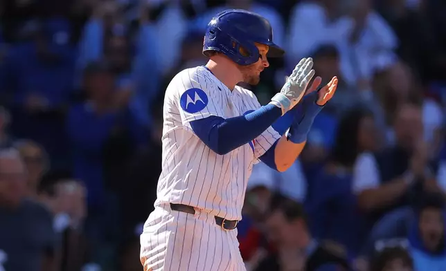 Chicago Cubs' Ian Happ celebrates after scoring on Nico Hoerner's RBI single during the sixth inning of a baseball game against the Miami Marlins, Thursday , Sept. 24, 2026, in Chicago. (AP Photo/Melissa Tamez)