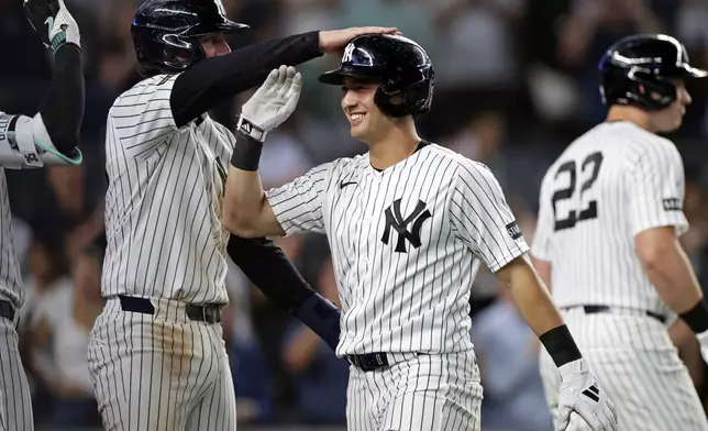 New York Yankees' Anthony Volpe is congratulated after hitting a grand slam during the seventh inning of a baseball game against the Colorado Rockies, Thursday, Sept. 10, 2026, in New York. (AP Photo/Adam Hunger)