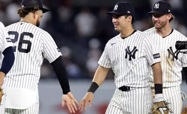 New York Yankees' Anthony Volpe celebrates with teammate after defeating the Colorado Rockies in a baseball game, Thursday, Sept. 10, 2026, in New York. (AP Photo/Adam Hunger)