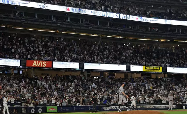 Colorado Rockies relief pitcher Jimmy Herget reacts after giving up a grand slam to New York Yankees' Anthony Volpe during the seventh inning of a baseball game Thursday, Sept. 10, 2026, in New York. (AP Photo/Adam Hunger)