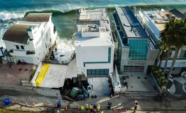 An aerial view of a sinkhole which collapsed the driveway of a coastal mansion owned by actor Nicolas Cage Tuesday, Sept. 8, 2026, in Malibu, Calif. (AP Photo/Ethan Swope)
