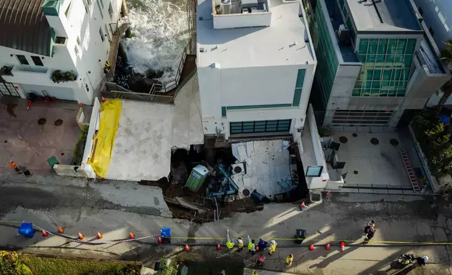 An aerial view of a sinkhole which collapsed the driveway of a coastal mansion owned by actor Nicolas Cage Tuesday, Sept. 8, 2026, in Malibu, Calif. (AP Photo/Ethan Swope)