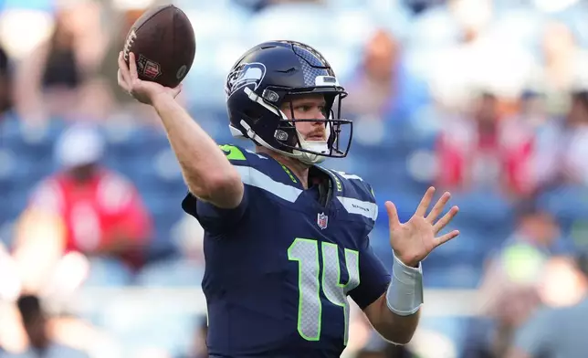 Seattle Seahawks quarterback Sam Darnold throws a pass during warmups before an NFL football game against the New England Patriots, Wednesday, Sept. 9, 2026, in Seattle. (AP Photo/Lindsey Wasson)