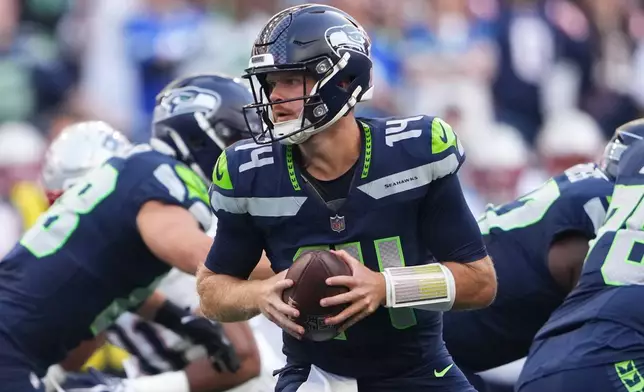 Seattle Seahawks quarterback Sam Darnold turns with the ball during the first half of an NFL football game against the New England Patriots, Wednesday, Sept. 9, 2026, in Seattle. (AP Photo/Lindsey Wasson)