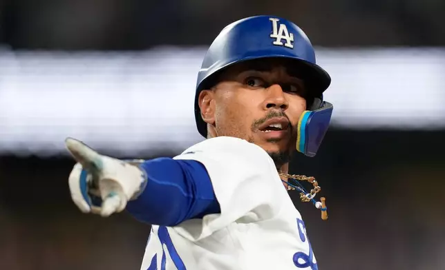Los Angeles Dodgers' Mookie Betts gestures after hitting a two-run home run during the eighth inning of a baseball game against the San Francisco Giants, Friday, Sept. 18, 2026, in Los Angeles. (AP Photo/Mark J. Terrill)