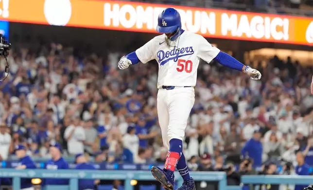 Los Angeles Dodgers' Mookie Betts scores after hitting a solo home run during the first inning of a baseball game against the San Francisco Giants, Friday, Sept. 18, 2026, in Los Angeles. (AP Photo/Mark J. Terrill)