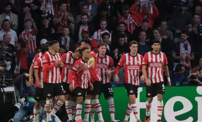PSV's Sergino Dest, center, celebrates with teammates after scoring his side's first goal during the Champions League opening phase soccer match between PSV and Shakhtar in Eindhoven, Netherlands, Thursday, Sept. 10, 2026. (AP Photo/Patrick Post)