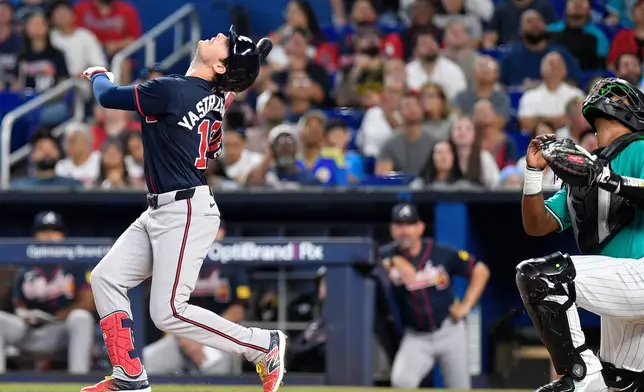 Atlanta Braves' Mike Yastrzemski, left, watches his foul ball during the second inning of a baseball game against the Miami Marlins, Sunday, Sept. 27, 2026, in Miami. (AP Photo/Michael Laughlin)