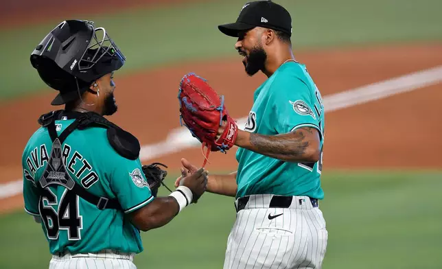 Miami Marlins Sandy Alcantara, right, celebrates beating the Atlanta Braves with catcher Brian Navarreto after the ninth inning of a baseball game, Sunday, Sept. 27, 2026, in Miami. (AP Photo/Michael Laughlin)