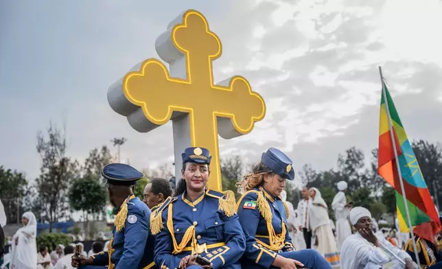 Members of Ethiopian Federal police march band look on during celebrations for the Orthodox holiday of Meskel, an annual holiday celebrating the discovery of the True Cross in the fourth century by the Roman Empress Helena, in Addis Ababa, Ethiopia, Saturday, Sept. 26, 2026. (AP Photo/Amanuel Sileshi)