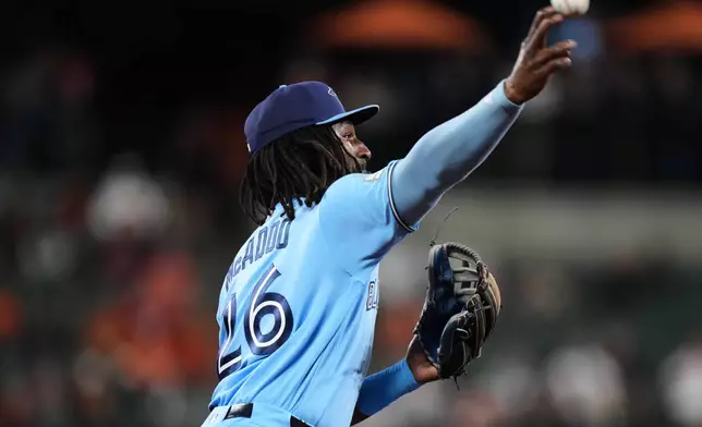 Toronto Blue Jays third baseman Charles McAdoo (26) throws to first to make the out against Baltimore Orioles' Pete Alonso during the third inning in the second baseball game of a doubleheader, Wednesday, Sept. 23, 2026, in Baltimore. (AP Photo/Stephanie Scarbrough)