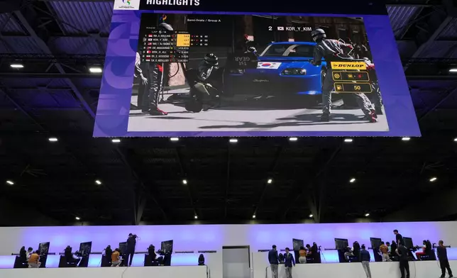 Competitors wait for final results following the Esports auto racing Gran Truismo 7 final at the Asian Games in Nagoya, Japan, Wednesday, Sept. 23, 2026. (AP Photo/Mark Baker)