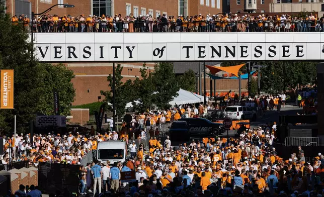 Fans watch from the bridge during the Vol Walk before an NCAA college football game between Tennessee and Texas, Saturday, Sept. 26, 2026, in Knoxville, Tenn. (AP Photo/Wade Payne)