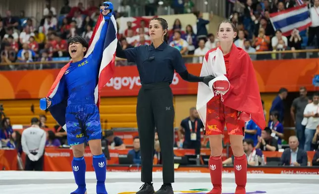 Kanjutha Phattaraboonsorn of Thailand, left, reacts after winning the women's modern 54kg mixed martial arts final against Diana Pogosian of Bahrain at the Asian Games in Nagoya, Japan, Tuesday, Sept. 22, 2026. (AP Photo/Dita Alangkara)