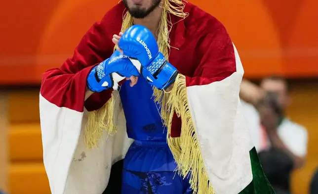 Mirzobek Umarov of Tajikistan reacts after winning the men's modern 60kg mixed martial arts final against Firdaus Atamuratov of Uzbekistan at the Asian Games in Nagoya, Japan, Tuesday, Sept. 22, 2026. (AP Photo/Dita Alangkara)