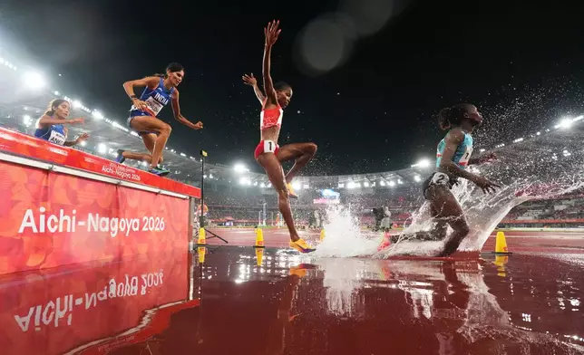 Athletes compete in the women's 3000m steeplechase final compete at the Asian Games in Nagoya, Sunday, Sept. 27, 2026. (AP Photo/Lee Jin-man)