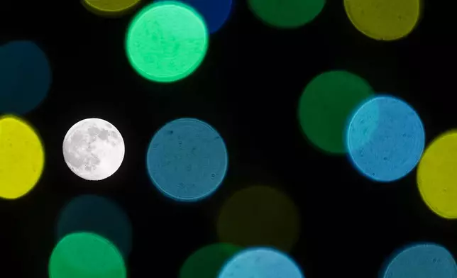 The Harvest Moon is seen during the Mid-Autumn Festival in Hong Kong, Friday, Sept. 25, 2026. (AP Photo/Chan Long Hei)