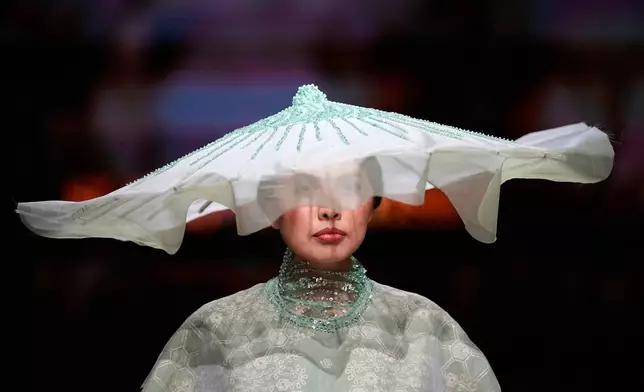 A model wears a creation by "Slava Zaitsev" at Moscow Fashion Week in Moscow, Saturday, Sept. 26, 2026. (AP Photo/Alexander Zemlianichenko)