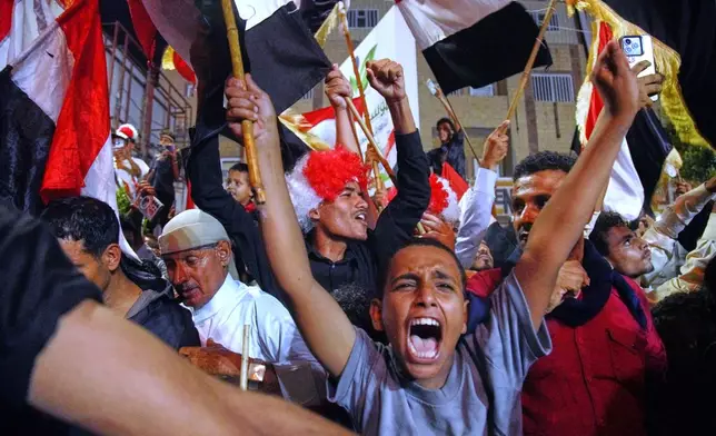 Yemenis wave national flags as they celebrate the 64th anniversary of the September 26 Revolution in government-controlled Taiz, Yemen, Friday, Sept. 25, 2026. (AP Photo/Abdulnasser Alseddik)