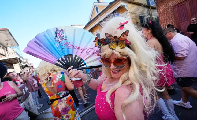 Members of the Krewe of Dolly lead a second line parade in commemoration of the life of Dolly Parton through the French Quarter Friday, Sept. 25, 2026, in New Orleans. (AP Photo/Gerald Herbert)