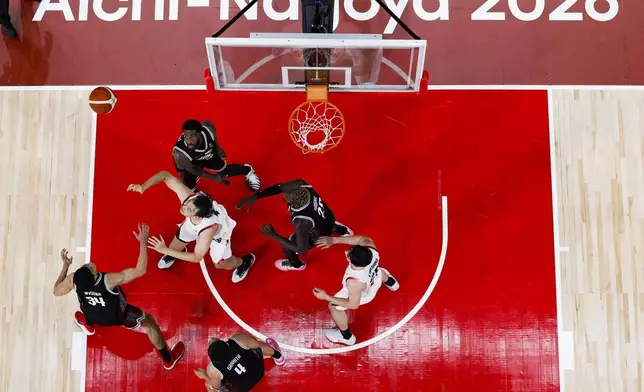 Team Japan players, in white, play against team Indonesia during their basketball game in the Asian Games in Nagoya, central Japan, on Sept. 10, 2026. (Jun Hirata/Kyodo News via AP)