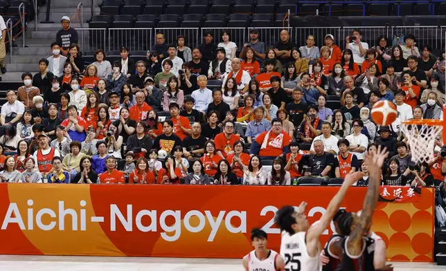 Team Japan players, in white, play against team Indonesia during their basketball game in the Asian Games in Nagoya, central Japan, on Sept. 10, 2026. (Natsumi Yasumoto/Kyodo News via AP)