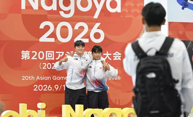 Athletes from South Korea take photos on their arrival at Chubu international airport in Tokoname, Aichi prefecture, Japan on Sept. 6, 2026, ahead of Asian Games. (Kasumi Fukudome/Kyodo News via AP)