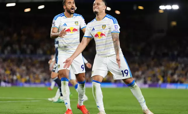 Leeds United's Noah Okafor, right, celebrates scoring their side's fourth goal with Dominic Calvert-Lewin during the English Premier League soccer match between Leeds United and Newcastle United in Leeds, England, Monday, Sept. 14, 2026. (Annabel Lee-Ellis/PA via AP)