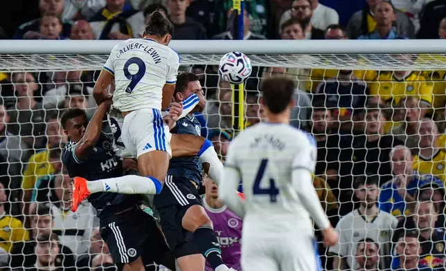 Leeds United's Dominic Calvert-Lewin, top, scores during the English Premier League soccer match between Leeds United and Newcastle United in Leeds, England, Monday Sept. 14, 2026. (Annabel Lee-Ellis/PA via AP)
