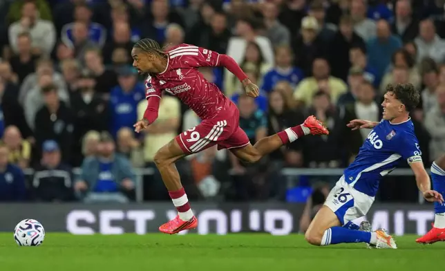 Liverpool's Bradley Barcola, centre, challenges for the ball with Ipswich Town's Dara O'Shea during the English Premier League soccer match between Ipswich Town and Liverpool in Ipswich, England, Friday, Sept. 4, 2026. (AP Photo/Dave Shopland)