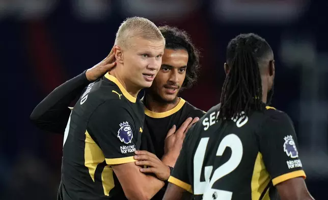 Manchester City's Erling Haaland, left, celebrates with Avyoub Bouaddi and Antoine Semenyo, right, after scoring his side's fourth goal during the English Premier League soccer match between Crystal Palace and Manchester City in London, Friday, Aug. 28, 2026. (AP Photo/Kin Cheung)