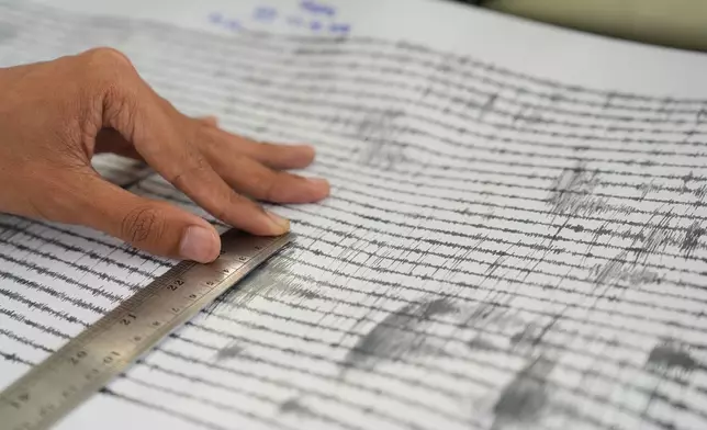 A technician measures the seismic readings from the eruption of Mount Anak Krakatau at an observation post in Pasauran, Banten province, Indonesia, Monday, Sept. 7, 2026. (AP Photo/Dziki Oktomauliyadi)