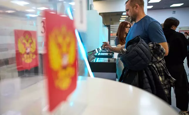 Voters use an electronic voting system in the parliamentary election in Moscow, Russia, Saturday, Sept. 19, 2026. (AP Photo/Alexander Zemlianichenko)
