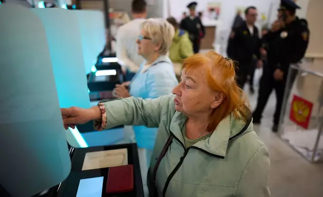 A voter uses an electronic voting system in the parliamentary election in Moscow, Russia, Saturday, Sept. 19, 2026. (AP Photo/Alexander Zemlianichenko)