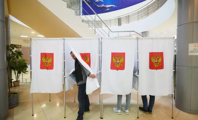 A voter leaves a polling booth after casting a vote during the parliamentary election in Podolsk, Moscow region, Russia, Saturday, Sept. 19, 2026. (AP Photo/Pavel Bednyakov)