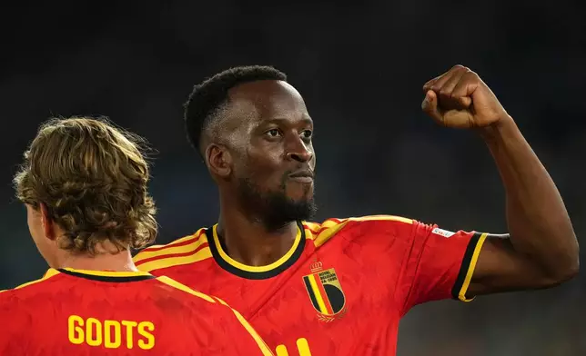 Belgium's Dodi Lukebakio celebrates with Mika Godts, left, after scoring his side's second goal during the Nations League soccer match between Italy and Belgium in Rome, Friday, Sept. 25, 2026. (AP Photo/Andrew Medichini)