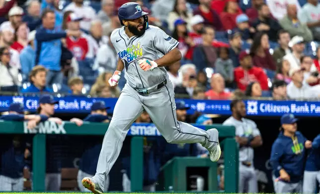 Tampa Bay Rays' Junior Caminero runs home to score on an RBI single by Jonny DeLuca in the first inning of a baseball game against the Philadelphia Phillies, Friday, Sept. 25, 2026, in Philadelphia. (AP Photo/Laurence Kesterson)