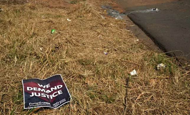 A poster is seen at a scene of a discovery of the body of a 38-year-old woman last week while jogging, in Kempton Park, east of Johannesburg, South Africa, Thursday, Sept. 17, 2026. (AP Photo/Themba Hadebe)