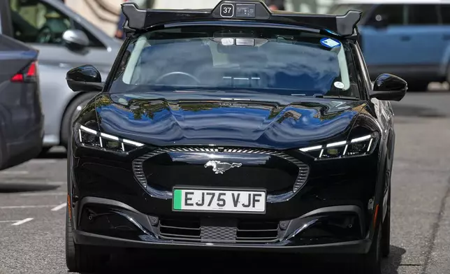 An autonomous car drives through the streets in Westminster, London, Tuesday, Sept. 1, 2026 as Uber officially launches the first hailable autonomous cabs in London.(AP Photo/Frank Augstein)