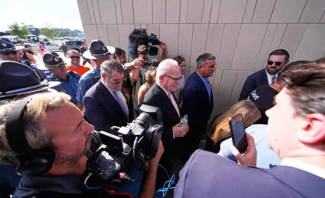 Defense attorney Kevin Reddington, center, leaves court, flanked by media and law enforcement, after the judge declared a mistrial in Lindsay Clancy's murder trial at Plymouth County Superior Court, Friday, Sept. 4, 2026, in Plymouth, Mass. (AP Photo/Charles Krupa)