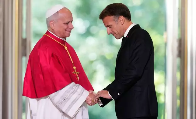 Pope Leo XIV, left, and French President Emmanuel Macron shake hands after a joint statement at the Elysee Palace, Friday, Sept. 25, 2026. (AP Photo/Teresa Suarez, Pool)